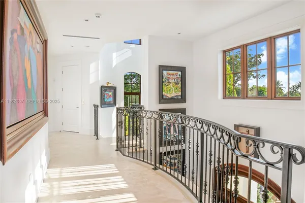 a view of a hallway with windows and stairs