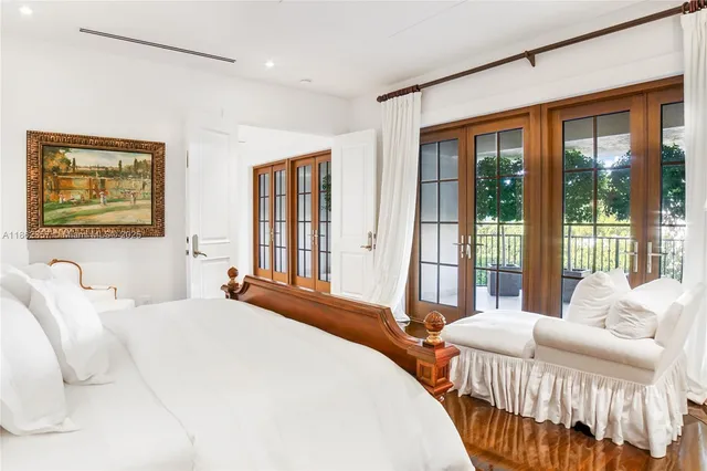 a bedroom with bed and a large window