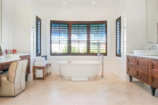 a spacious bedroom with a bed and a large window