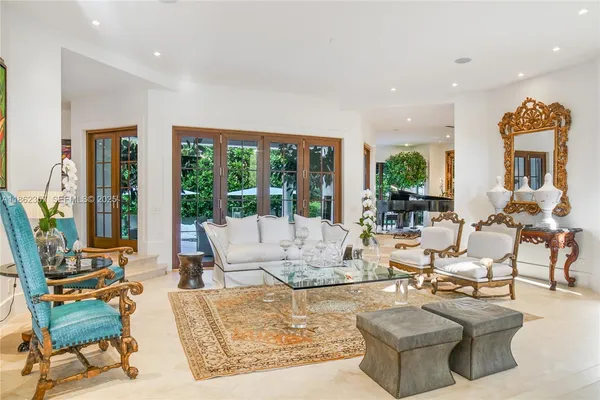 a living room with fireplace furniture and a large window