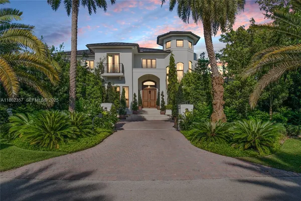 a front view of a house with a garden