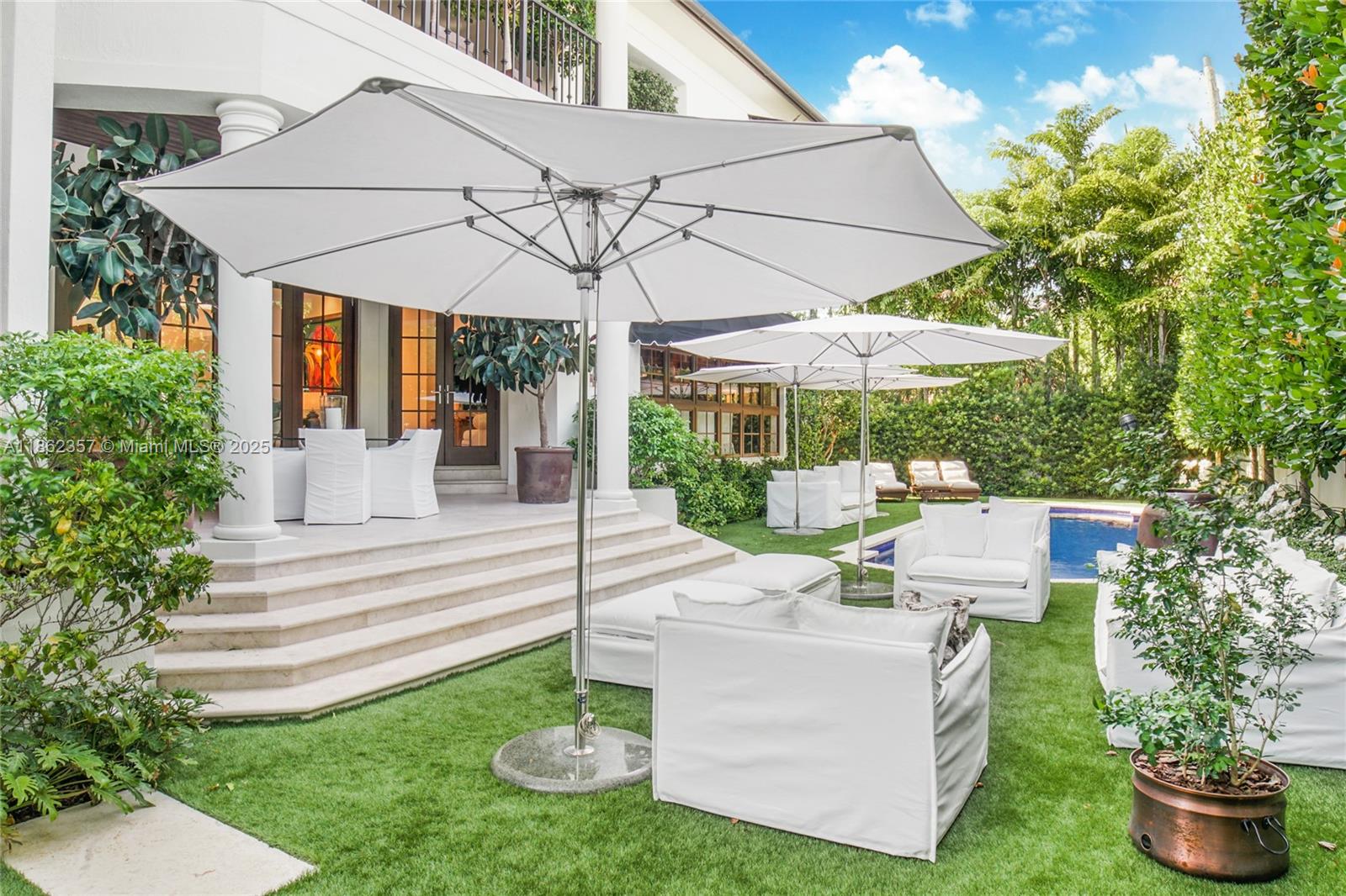365 Gulf Road Key Biscayne, FL 33149 - Photo 5 of 29 a view of a chair and table in backyard of the house