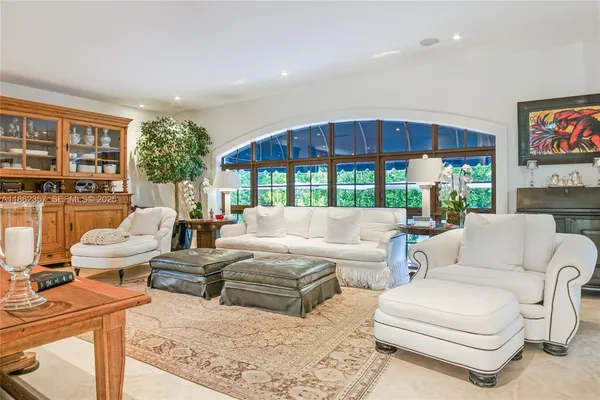 a living room with furniture a lamp and a table