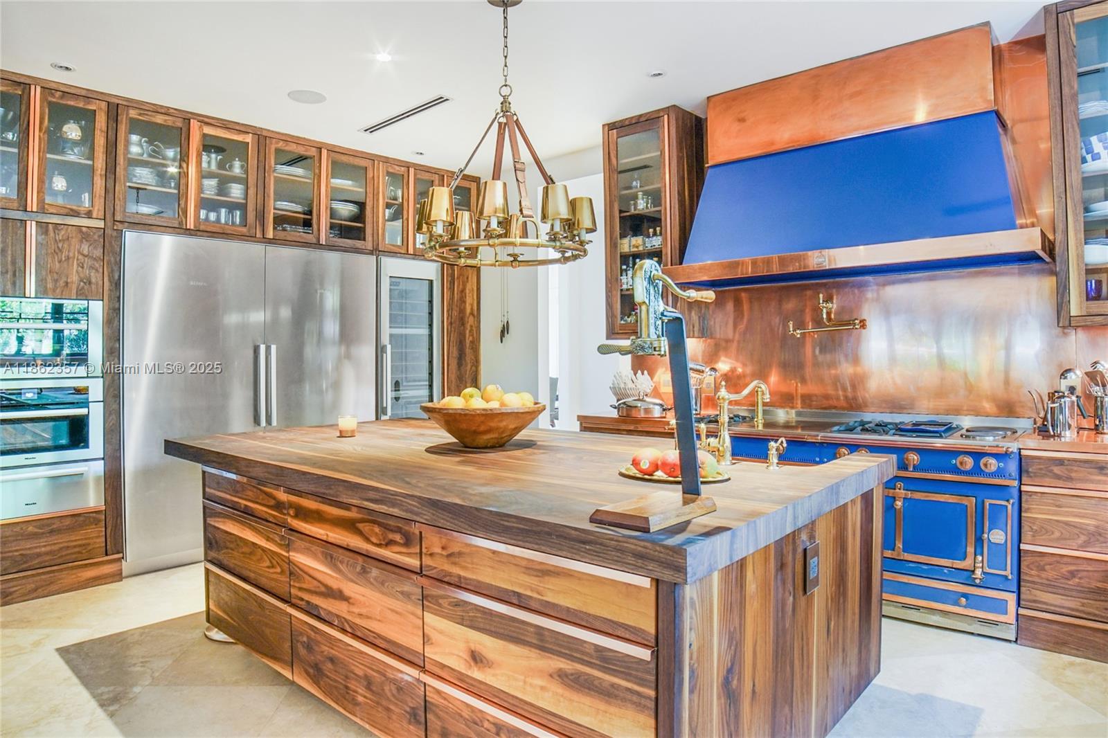 365 Gulf Road Key Biscayne, FL 33149 - Photo 8 of 29 a kitchen with stainless steel appliances granite countertop a stove and a wooden cabinets