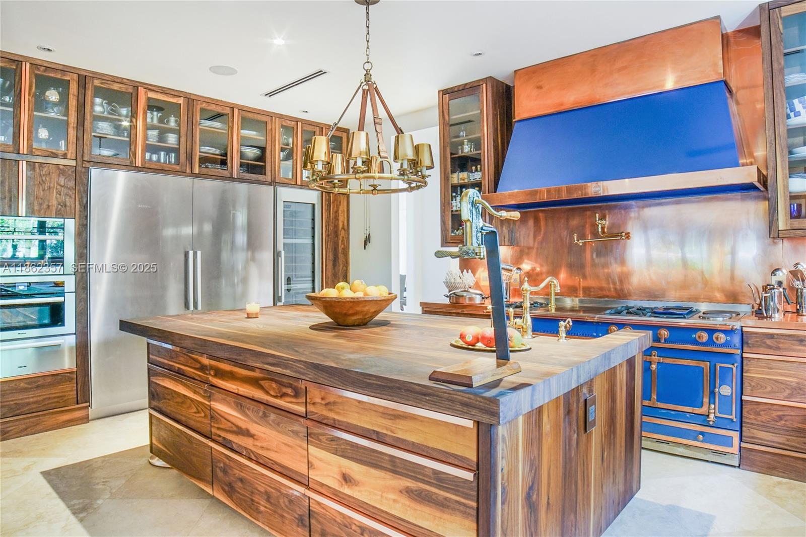 365 Gulf Road Key Biscayne, FL 33149 - Photo 8 of 29 a kitchen with stainless steel appliances granite countertop a stove and a wooden cabinets