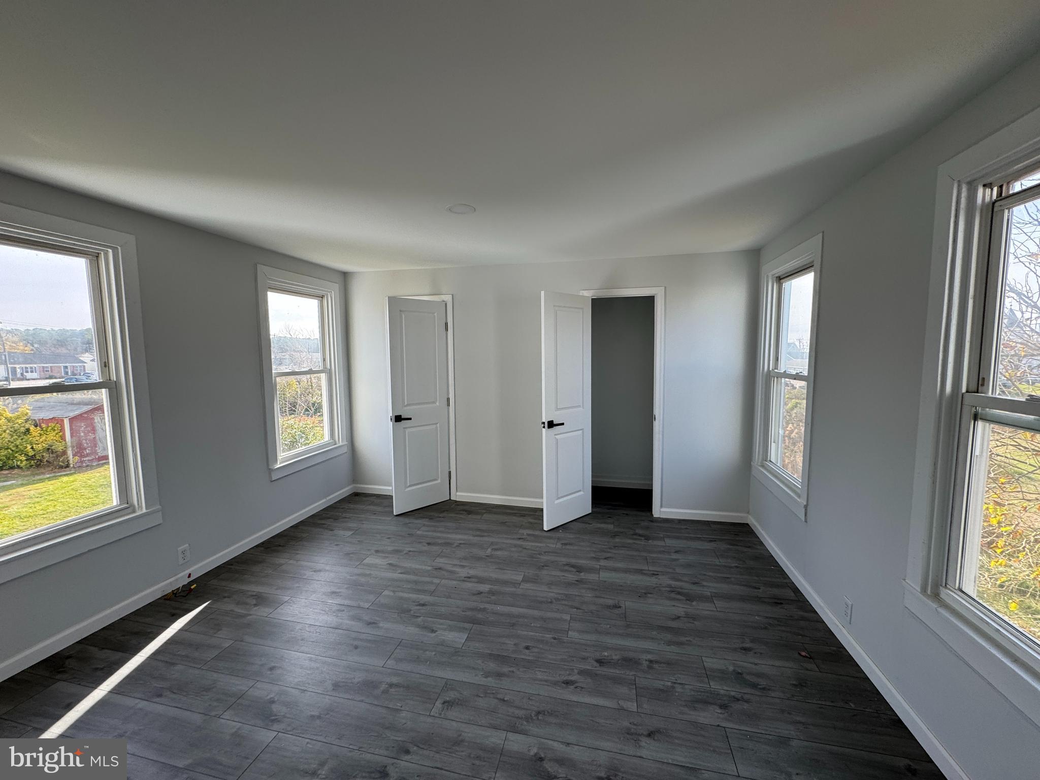 313 Broadway Crisfield, MD 21817 - Photo 12 of 15 an empty room with wooden floor and windows