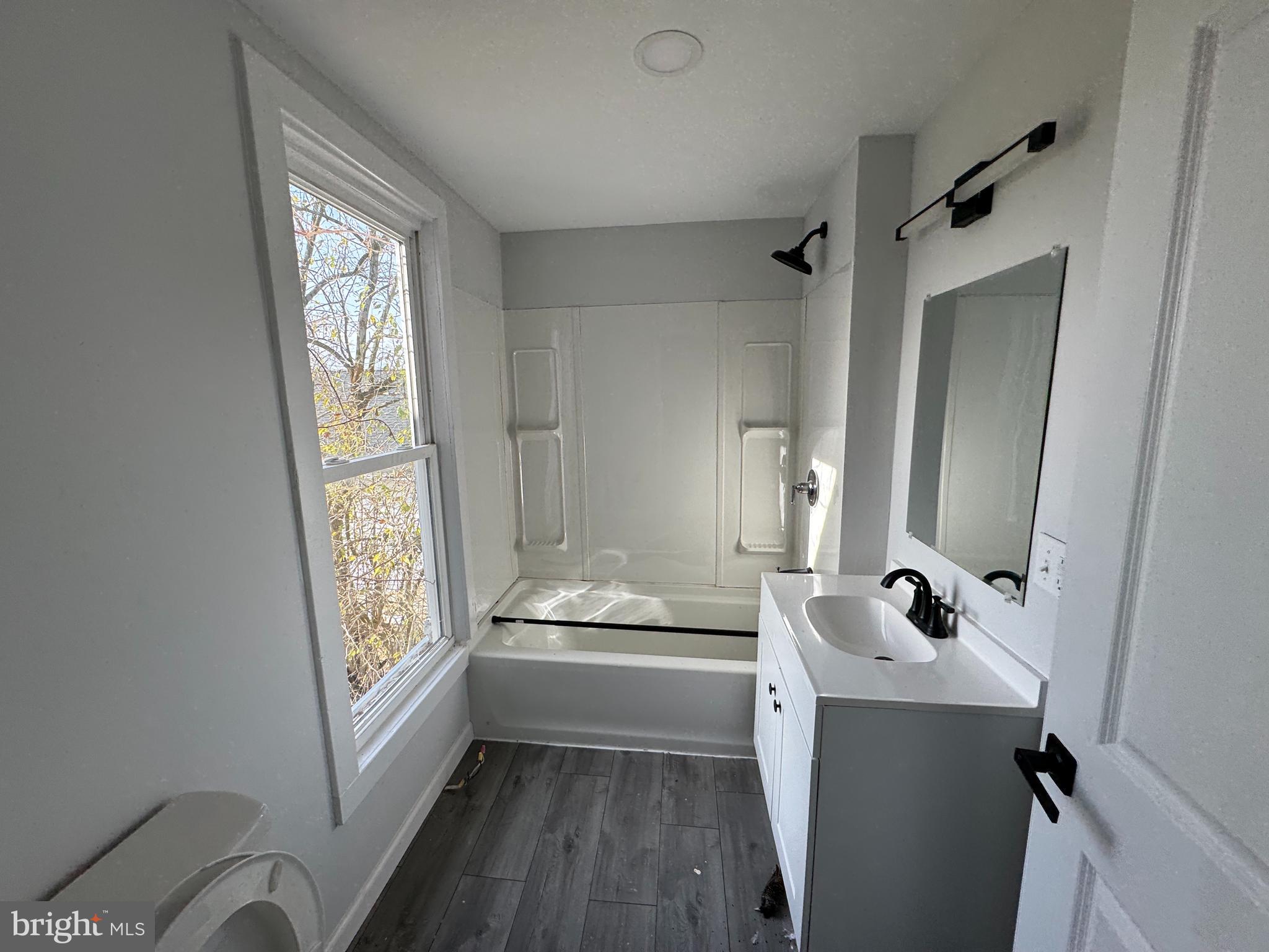 313 Broadway Crisfield, MD 21817 - Photo 13 of 15 a bathroom with a sink a toilet and a mirror