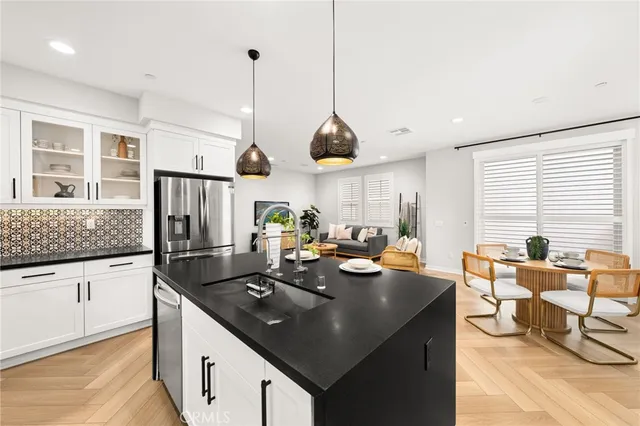 a kitchen with granite countertop a sink a counter top space and living room view