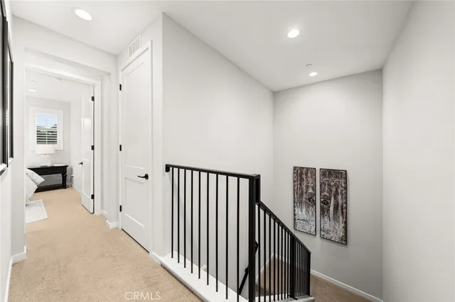 a view of a hallway with entryway and stairs