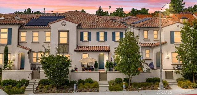 a front view of a residential apartment building with a garden