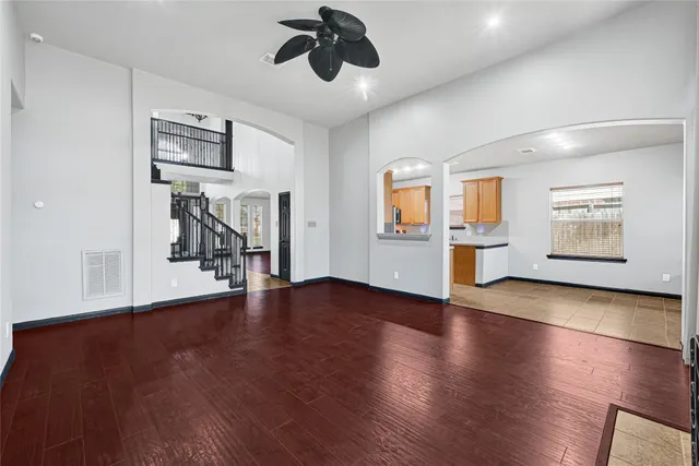 a view of a livingroom with hardwood floor and a ceiling fan