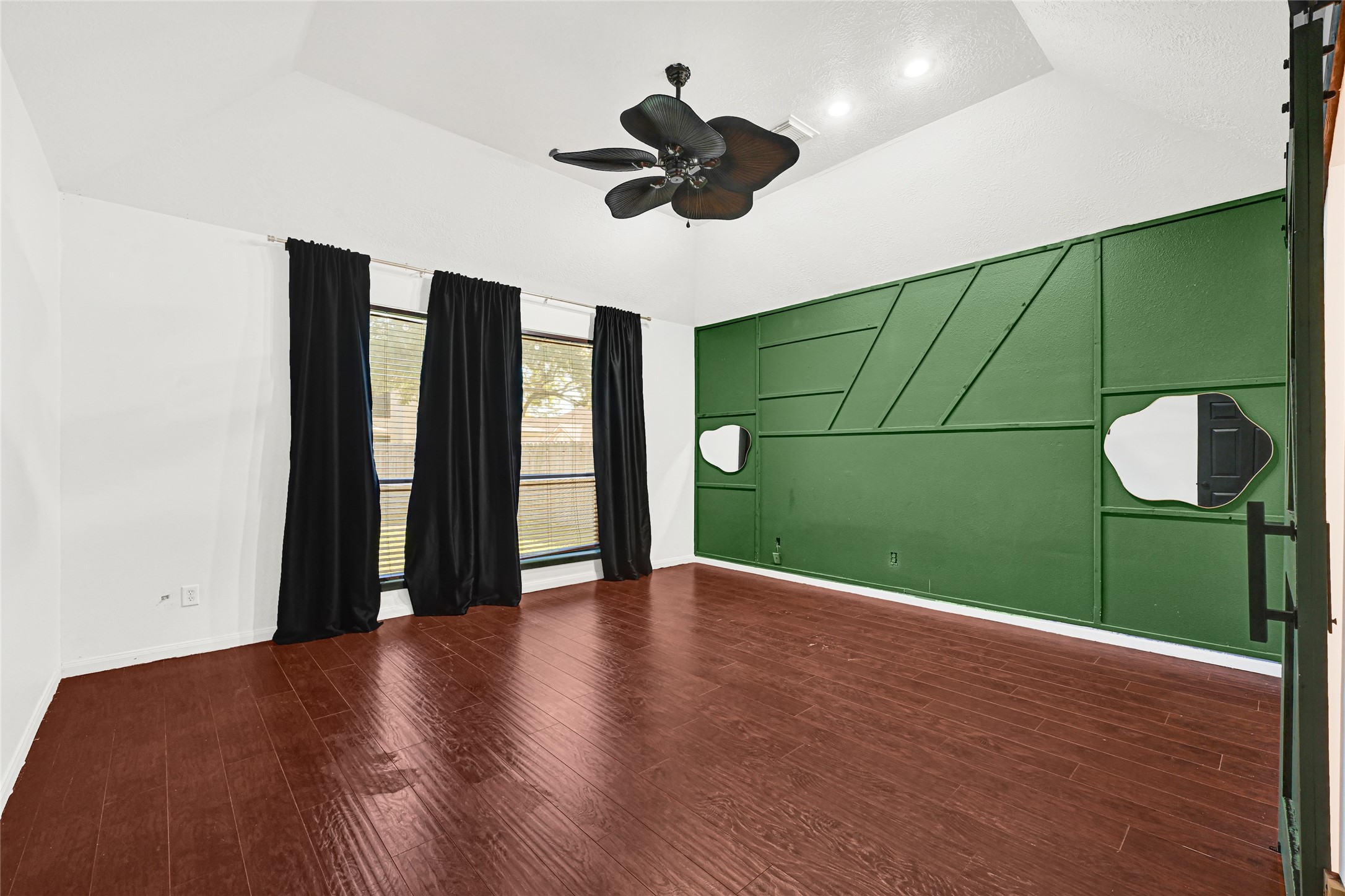 8514 Discus Drive Humble, TX 77346 - Photo 17 of 32 a view of an empty room with wooden floor and a ceiling fan