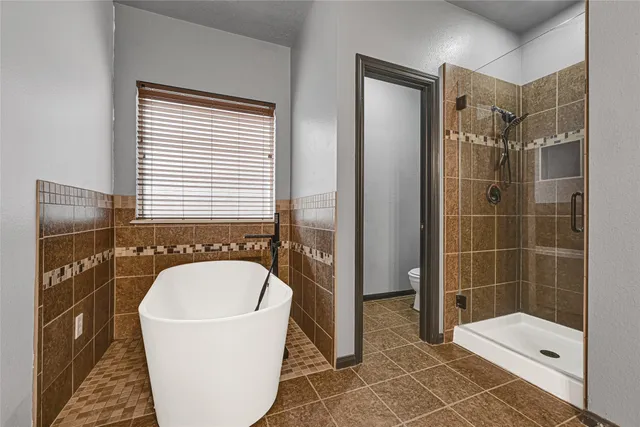 a bathroom with a bathtub and shower