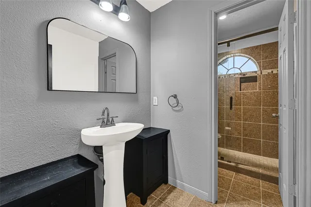 a bathroom with a toilet a sink and a shower