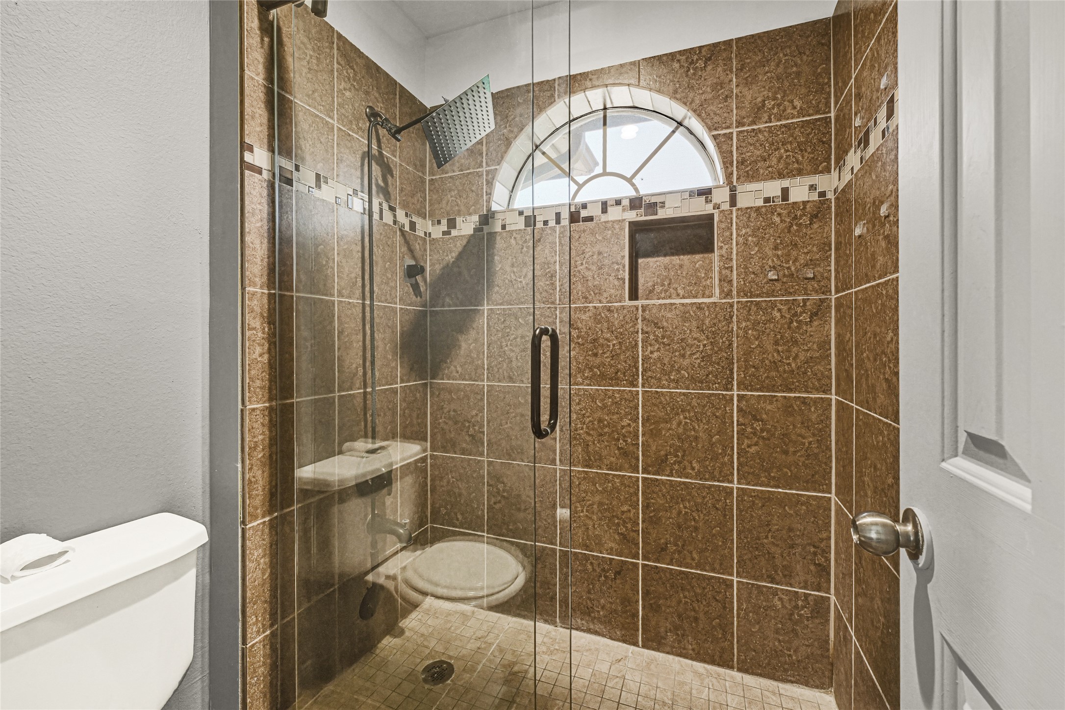 8514 Discus Drive Humble, TX 77346 - Photo 27 of 32 a bathroom with a toilet a sink and a shower