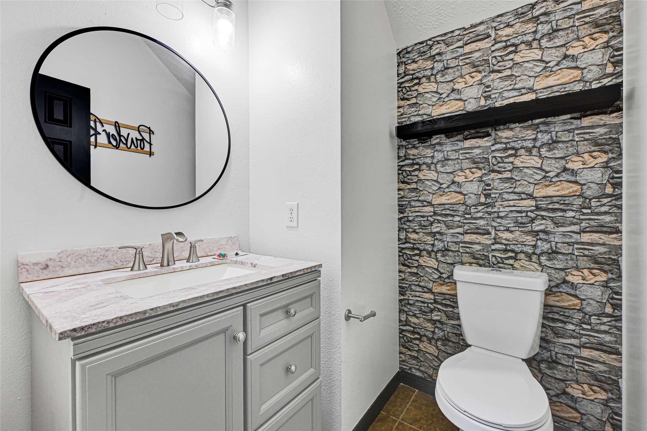 8514 Discus Drive Humble, TX 77346 - Photo 9 of 32 a bathroom with a toilet sink vanity and mirror