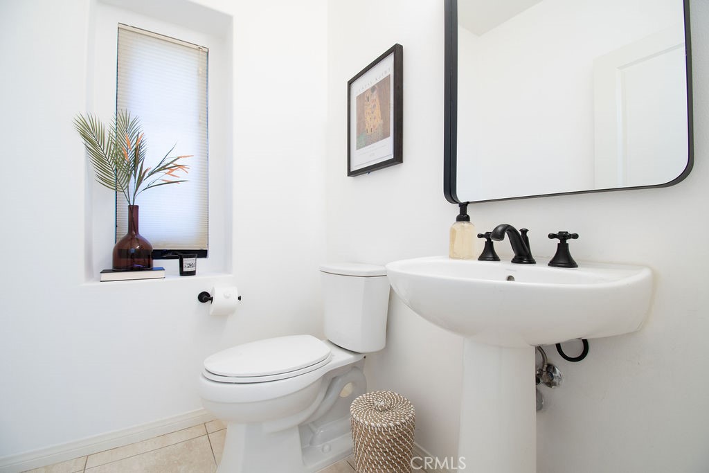 58 Cipresso Irvine, CA 92618 - Photo 13 of 34 a bathroom with a toilet a sink and a mirror