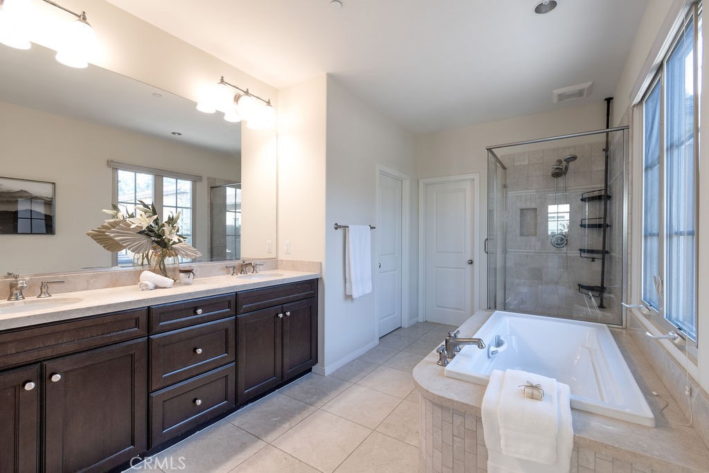 58 Cipresso Irvine, CA 92618 - Photo 16 of 34 a spacious bathroom with a granite countertop sink mirror and shower