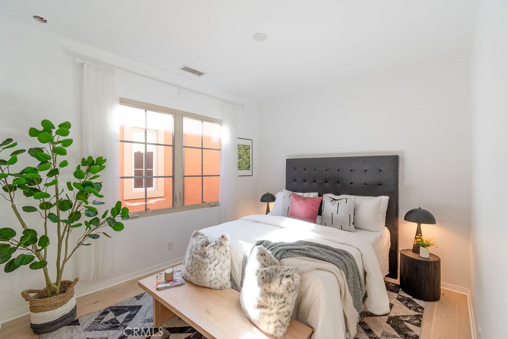 58 Cipresso Irvine, CA 92618 - Photo 17 of 34 a bedroom with a bed and a potted plant