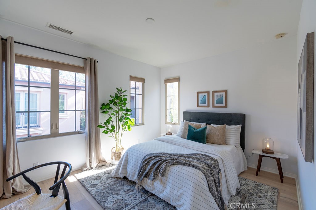 58 Cipresso Irvine, CA 92618 - Photo 18 of 34 a bedroom with a large bed and a table