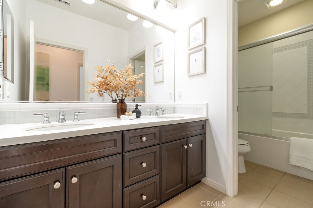 58 Cipresso Irvine, CA 92618 - Photo 19 of 34 a bathroom with a granite countertop sink mirror and toilet
