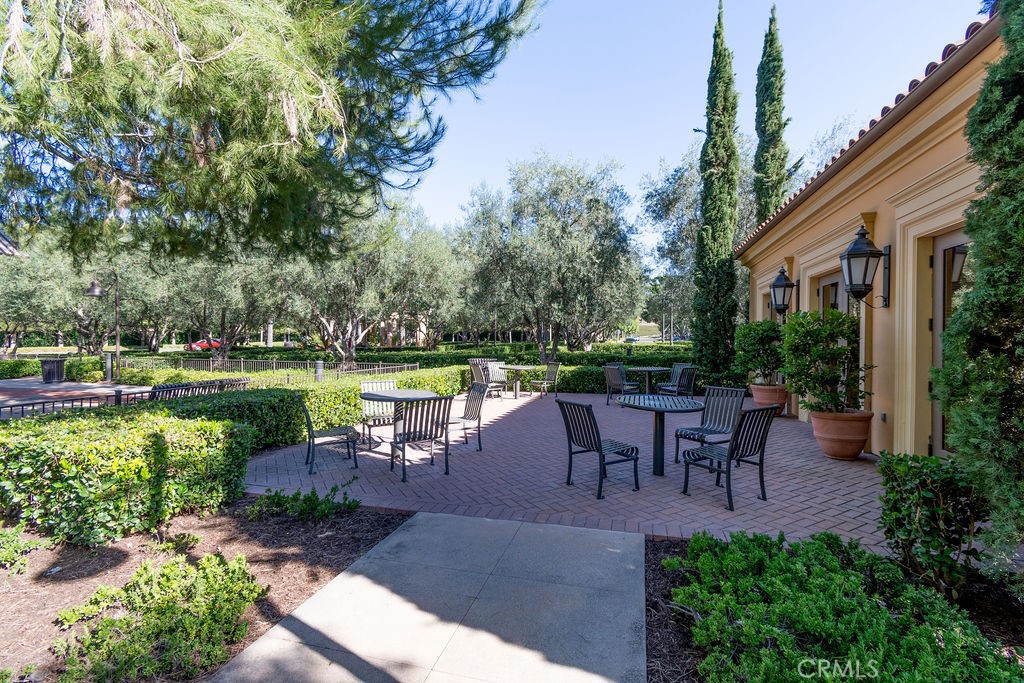58 Cipresso Irvine, CA 92618 - Photo 31 of 34 a view of a patio with table and chairs potted plants and a large tree