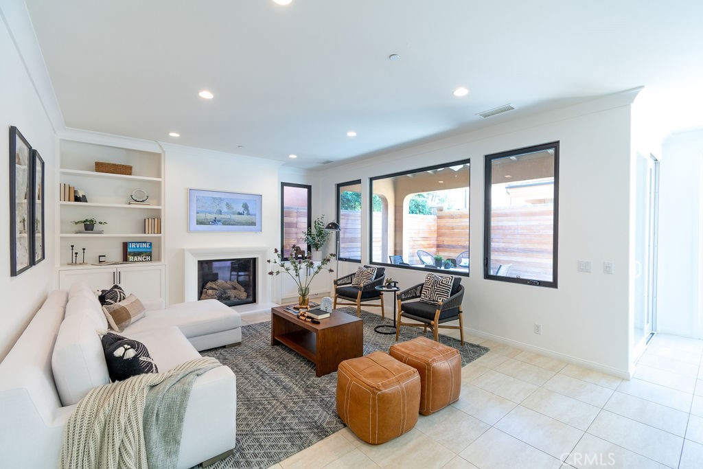 58 Cipresso Irvine, CA 92618 - Photo 4 of 34 a living room with furniture large window and a fireplace