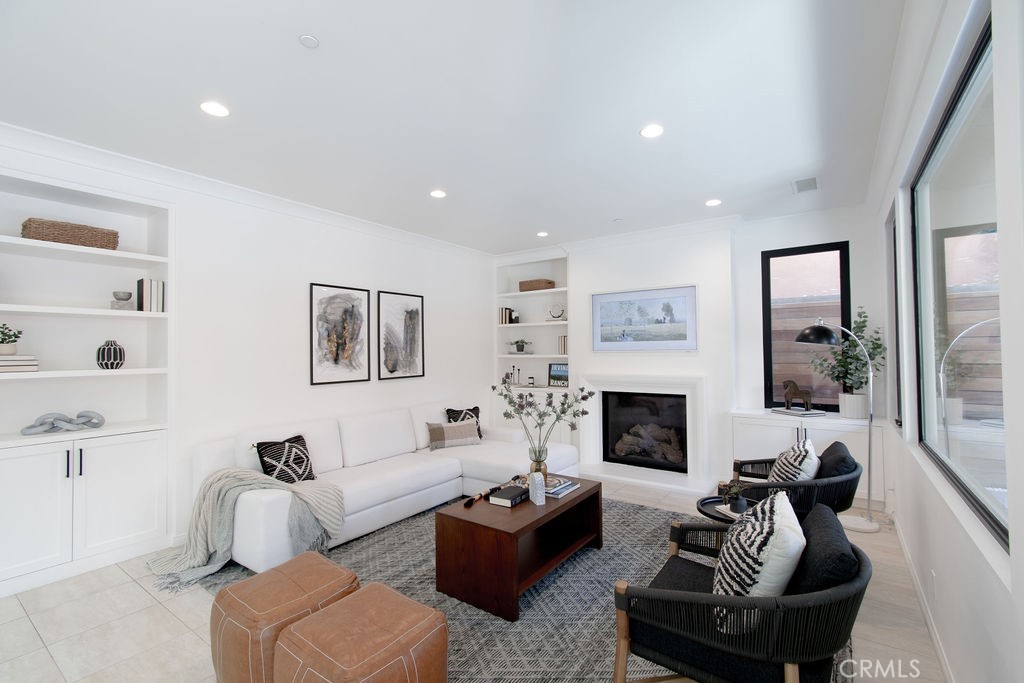 58 Cipresso Irvine, CA 92618 - Photo 5 of 34 a living room with furniture potted plant and a fireplace