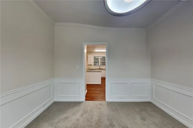 a view of an empty room and closet with wooden floor