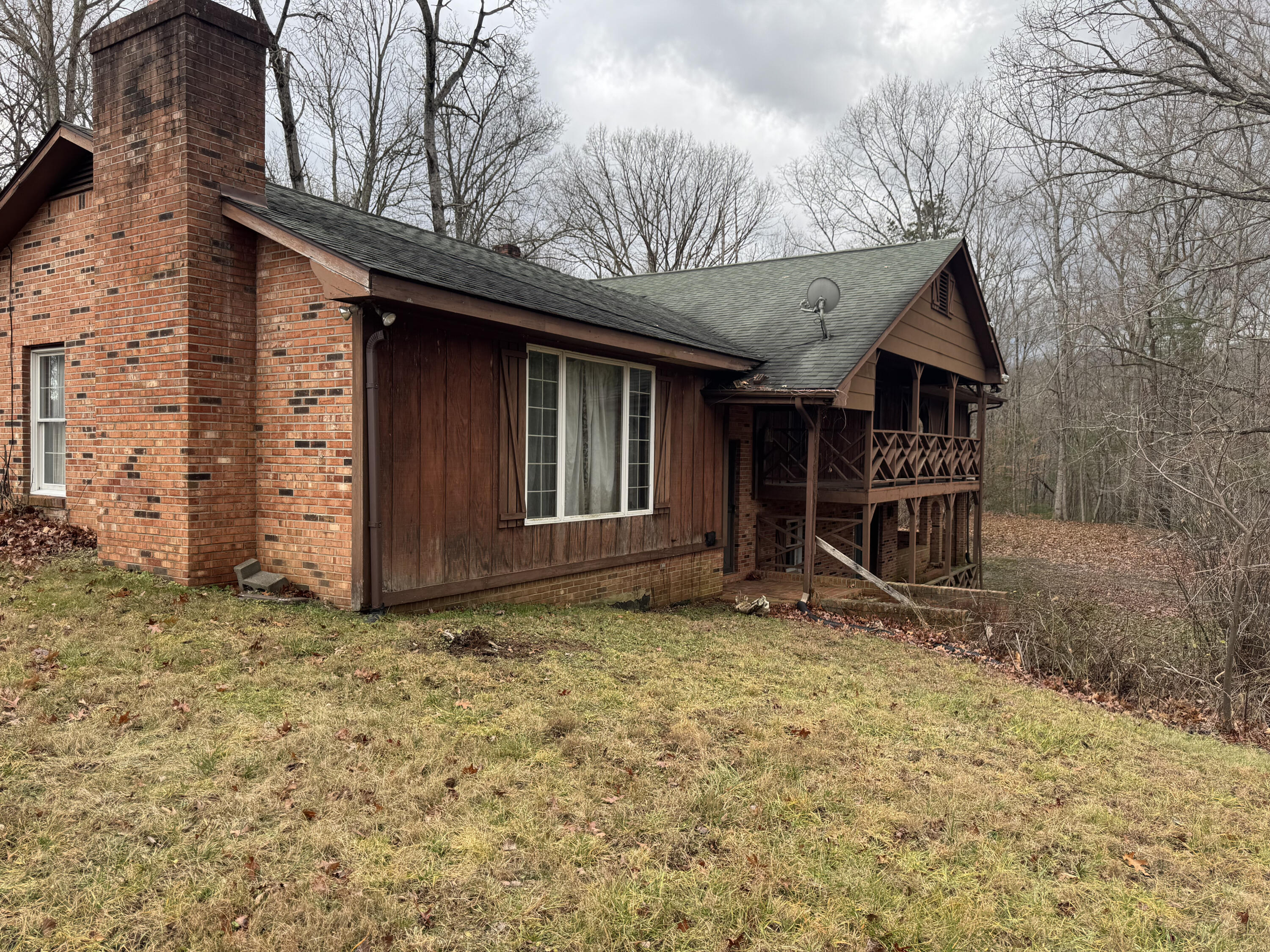 5341 Robinson Tract Road Pulaski, VA 24301 - Photo 22 of 32 a view of a house with wooden fence and a large tree
