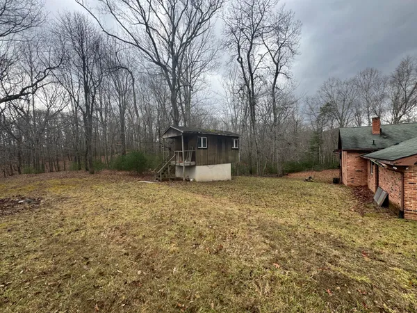a backyard of a house with table and chairs