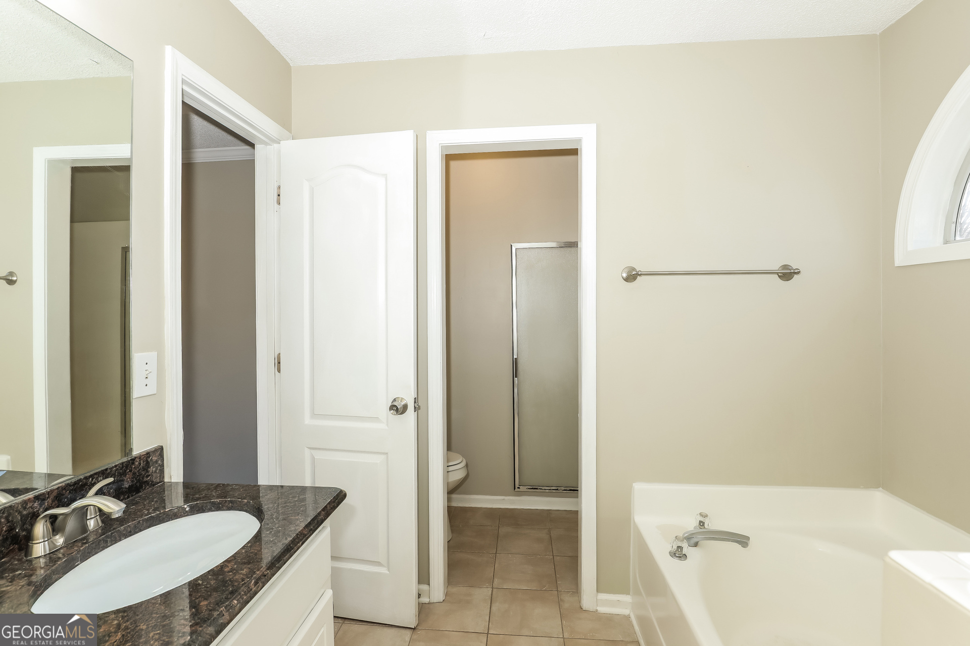 1085 Commons Court Jonesboro, GA 30238 - Photo 14 of 21 a bathroom with a granite countertop sink a mirror and a bathtub