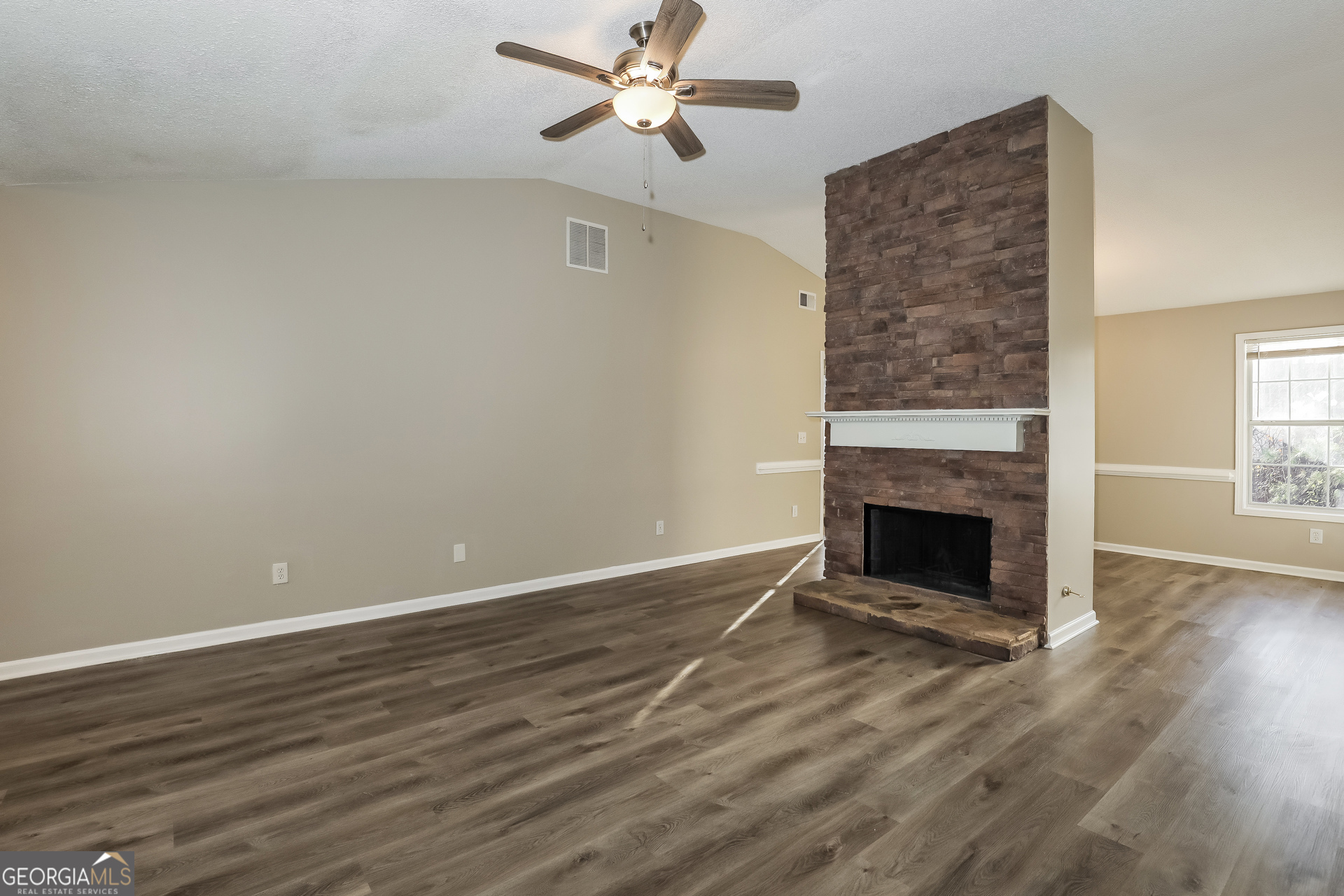 1085 Commons Court Jonesboro, GA 30238 - Photo 3 of 21 a view of empty room with wooden floor and fireplace
