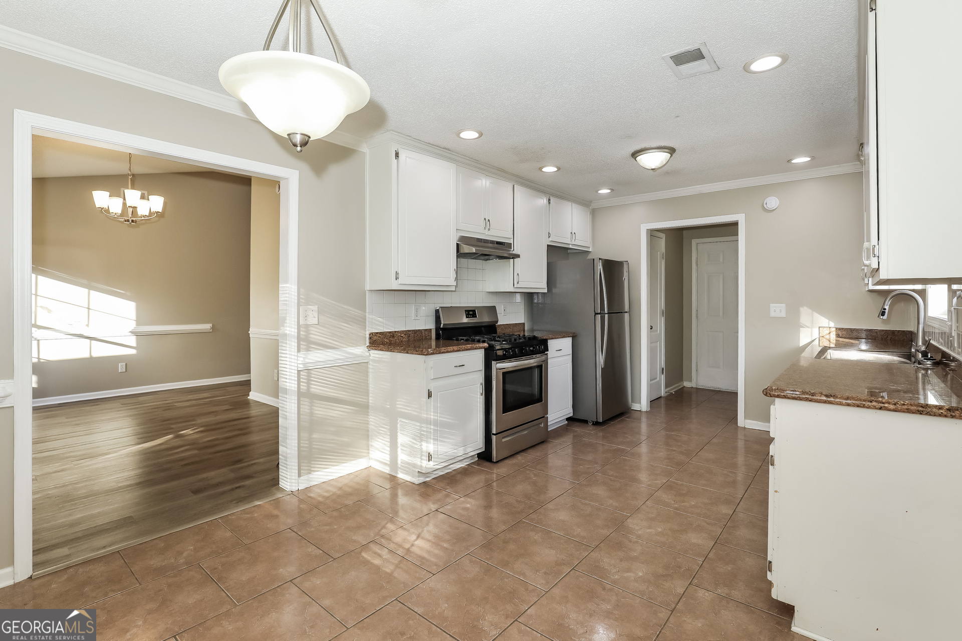1085 Commons Court Jonesboro, GA 30238 - Photo 7 of 21 a kitchen with stainless steel appliances granite countertop a stove a sink and a refrigerator