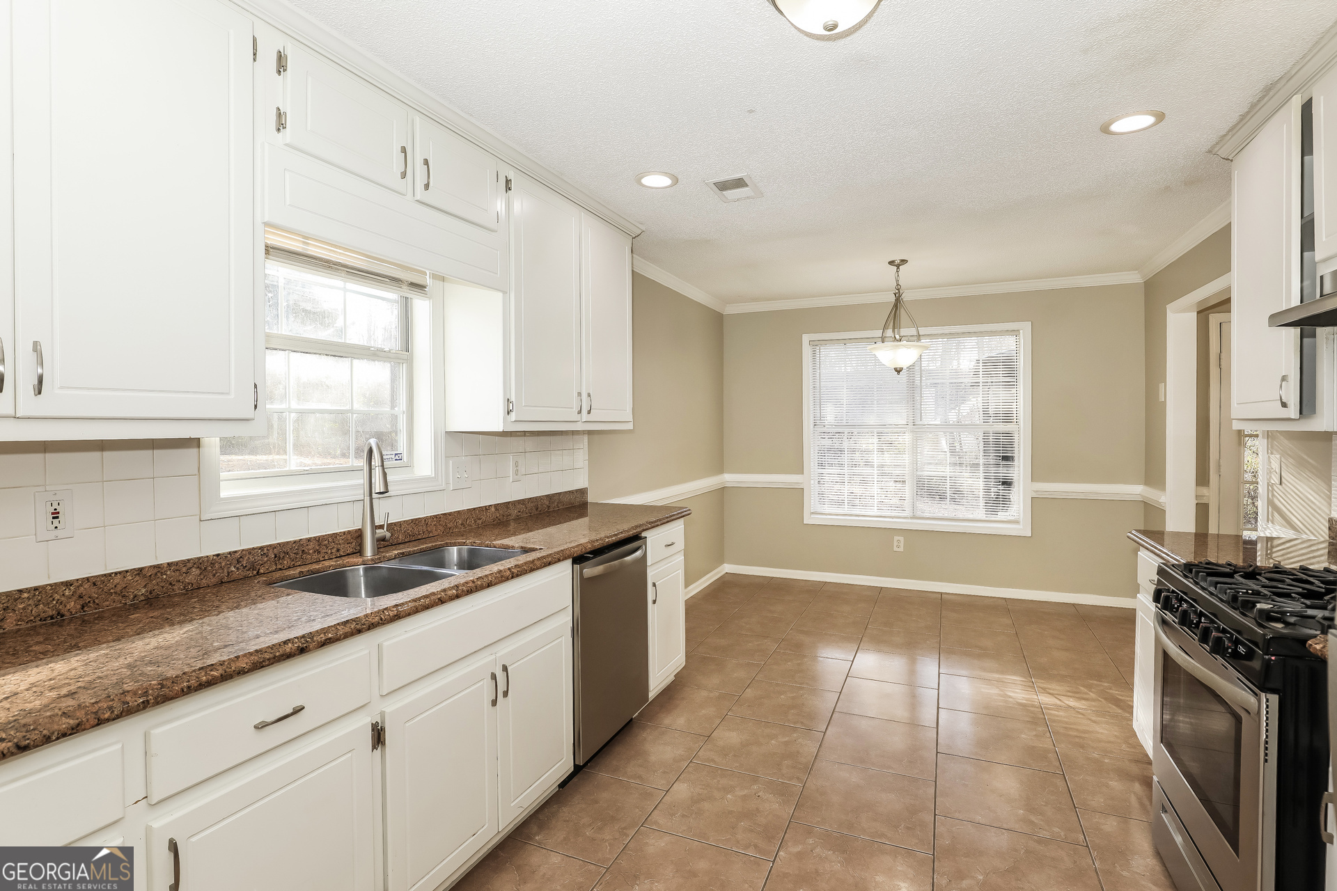 1085 Commons Court Jonesboro, GA 30238 - Photo 9 of 21 a kitchen with granite countertop a sink stove and cabinets