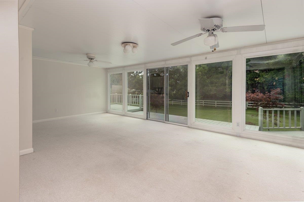 670 Peterson Lake Road Collierville, TN 38017 - Photo 7 of 37 Spacious interior room with light-toned carpeting and multiple ceiling fans