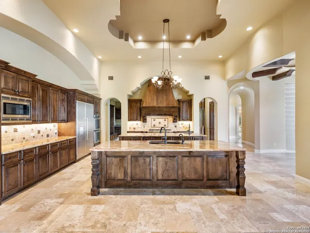 a large kitchen with a sink and cabinets
