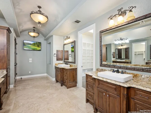 a bathroom with a sink vanity and a mirror