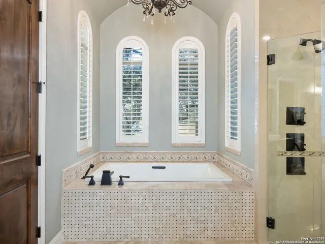 a bathroom with a bathtub and shower