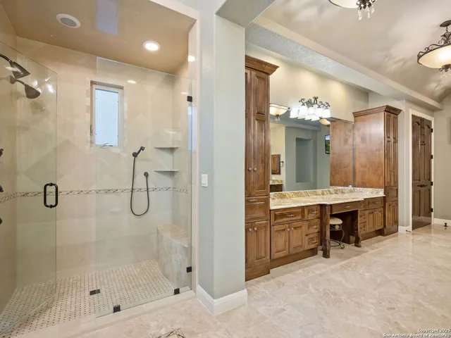 a bathroom with a shower sink and mirror