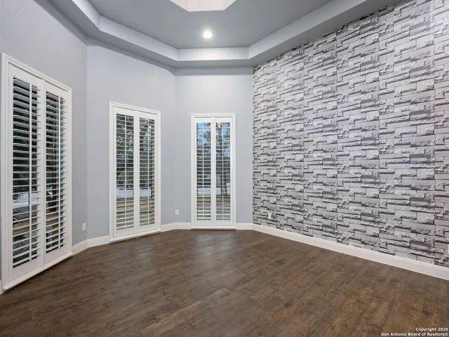 a bathroom with a granite countertop toilet sink and mirror