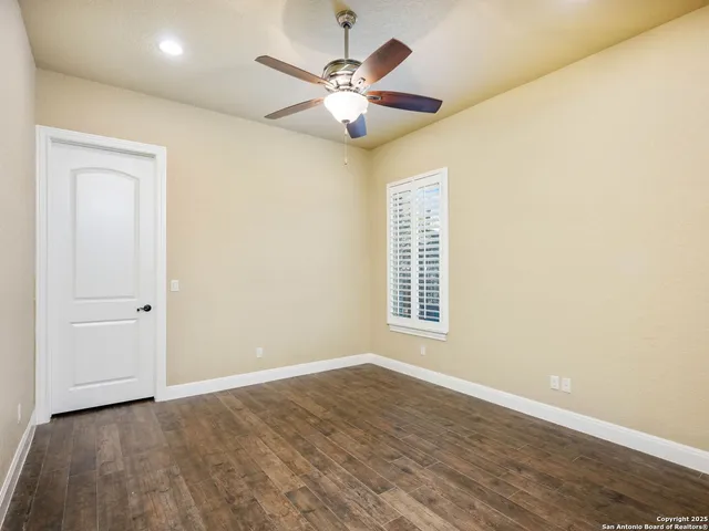 a bathroom with a granite countertop sink a toilet and a mirror