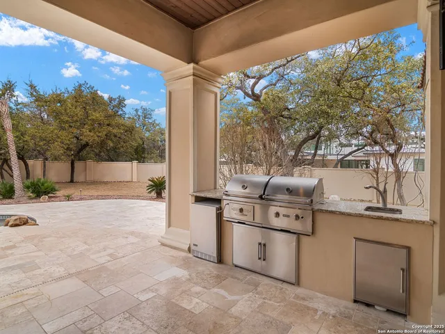a view of a house with swimming pool and sitting area