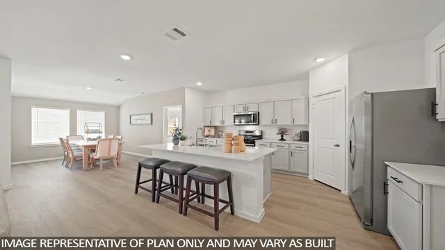 a living room with stainless steel appliances kitchen island granite countertop furniture and a dining table
