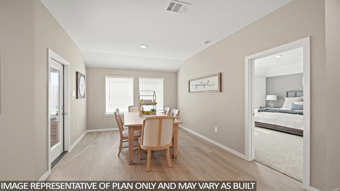 14266 Moon Flower Drive Splendora, TX 77372 - Photo 4 of 18 a view of a dining room with furniture and wooden floor