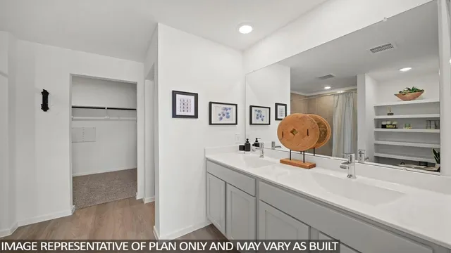 a bathroom with a sink mirror and vanity