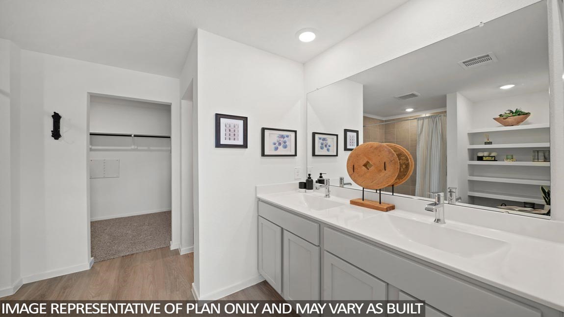 14266 Moon Flower Drive Splendora, TX 77372 - Photo 7 of 18 a bathroom with a sink mirror and vanity