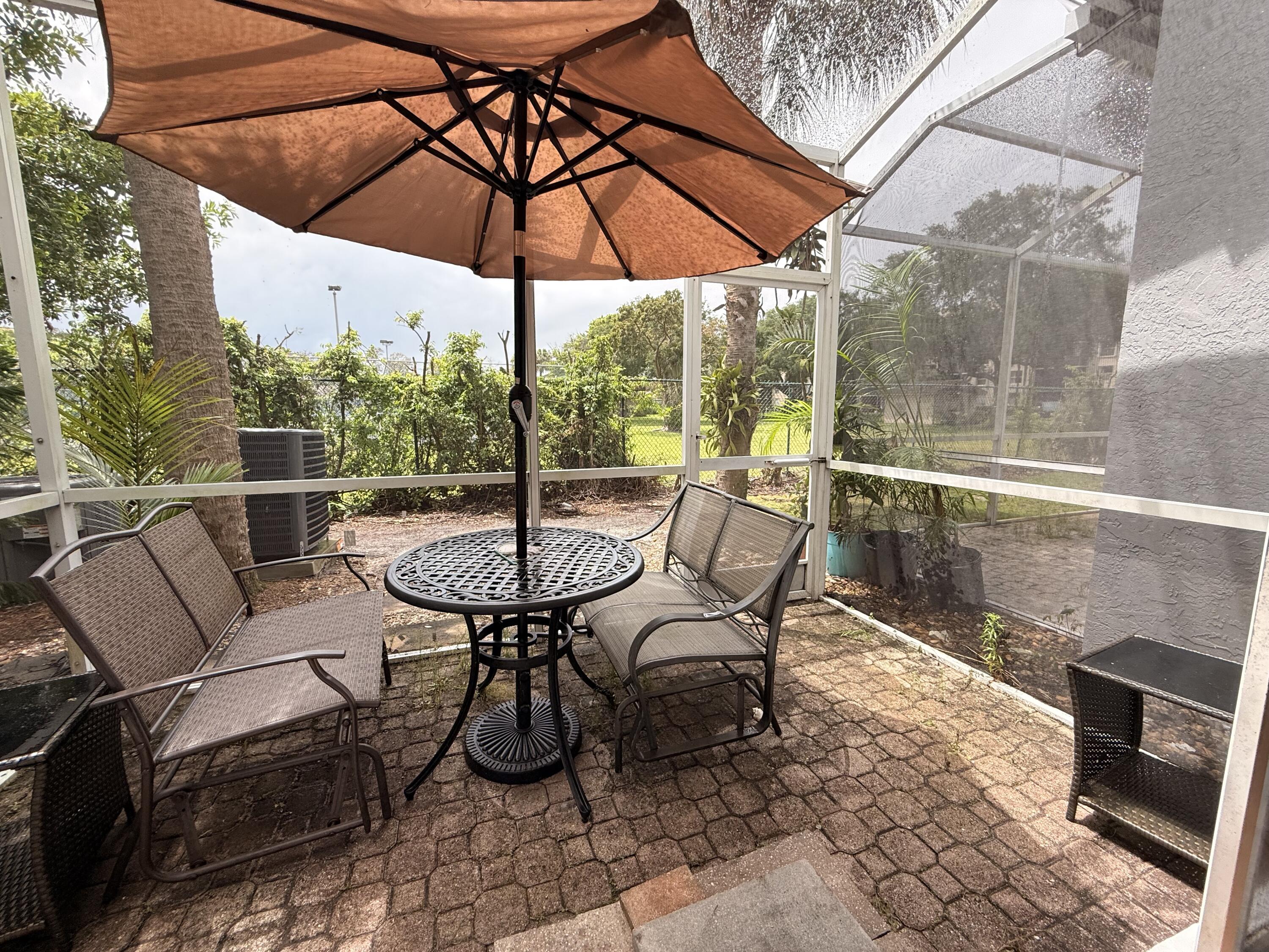 5121 Sabal Gardens Lane, Unit 2 Boca Raton, FL 33487 - Photo 11 of 25 Back patio. Screened in