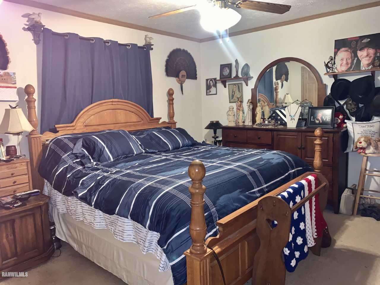 6639 Riverview Road Thomson, IL 61285 - Photo 13 of 20 a bed sitting in a bedroom next to a dresser