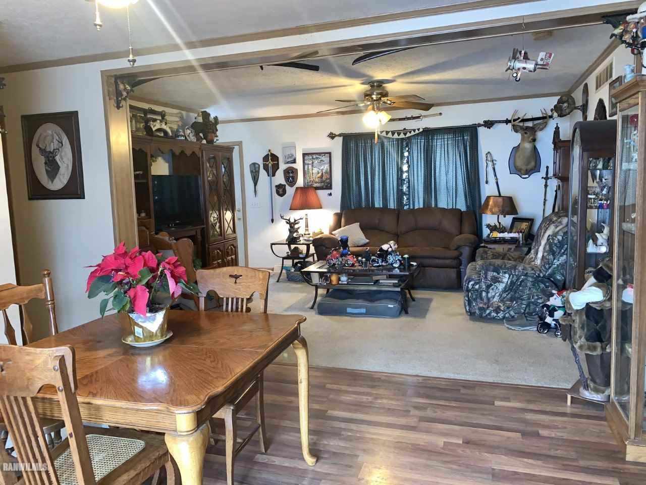6639 Riverview Road Thomson, IL 61285 - Photo 6 of 20 a living room filled with furniture and a chandelier